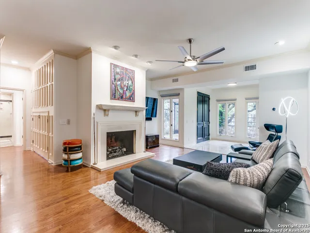 a living room with furniture a fireplace and a large window