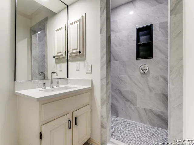 a bathroom with a sink and a mirror