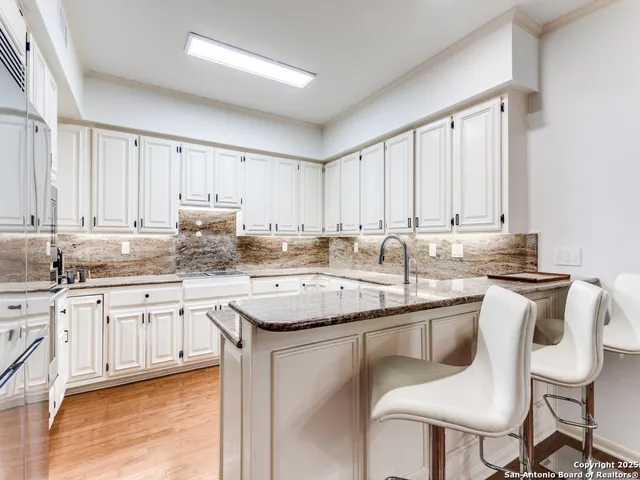 a kitchen with stainless steel appliances granite countertop a sink and cabinets