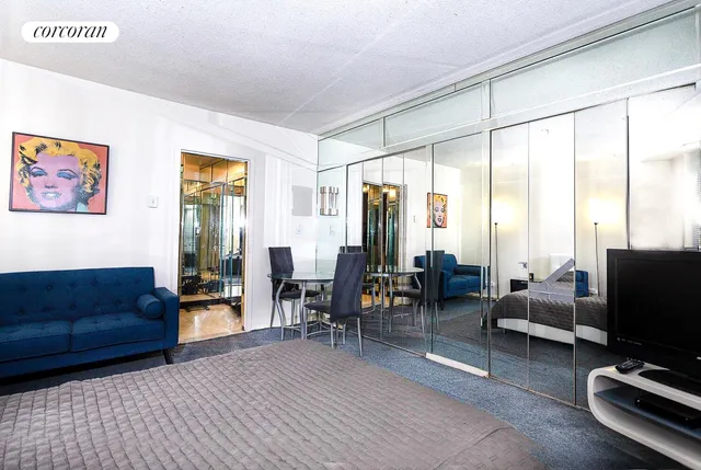 a living room with furniture a large window and a flat screen tv