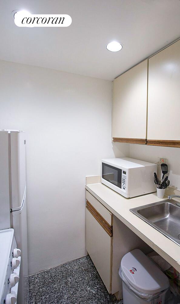 210 East 47th Street, Unit 8G Manhattan, NY 10017 - Photo 4 of 6 a bathroom with a sink a toilet and a mirror