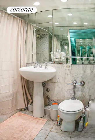 a bathroom with a toilet sink and shower