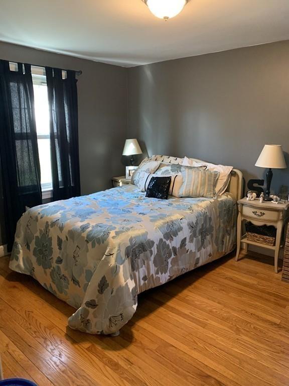 17 Daley Street Leominster, MA 01453 - Photo 18 of 21 a bedroom with a bed and wooden floor