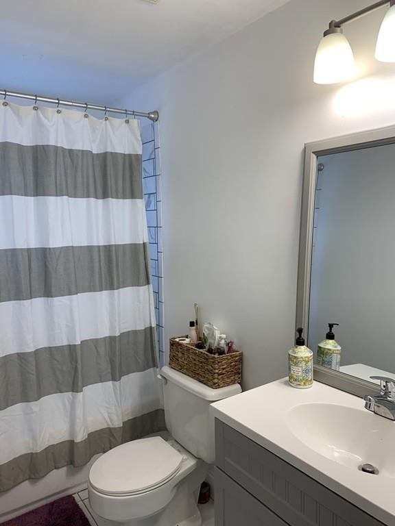 17 Daley Street Leominster, MA 01453 - Photo 21 of 21 a bathroom with a sink a toilet a mirror and shower curtain