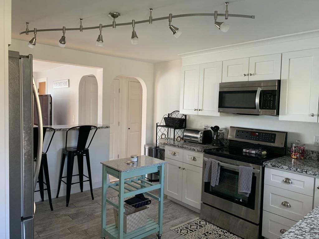 17 Daley Street Leominster, MA 01453 - Photo 8 of 21 a kitchen with stainless steel appliances a stove a sink and a refrigerator