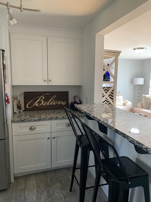 17 Daley Street Leominster, MA 01453 - Photo 9 of 21 a kitchen with a table chairs stove and cabinets