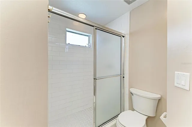 a white toilet sitting next to a bathroom sink