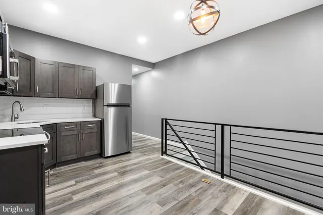 a kitchen with refrigerator and cabinets