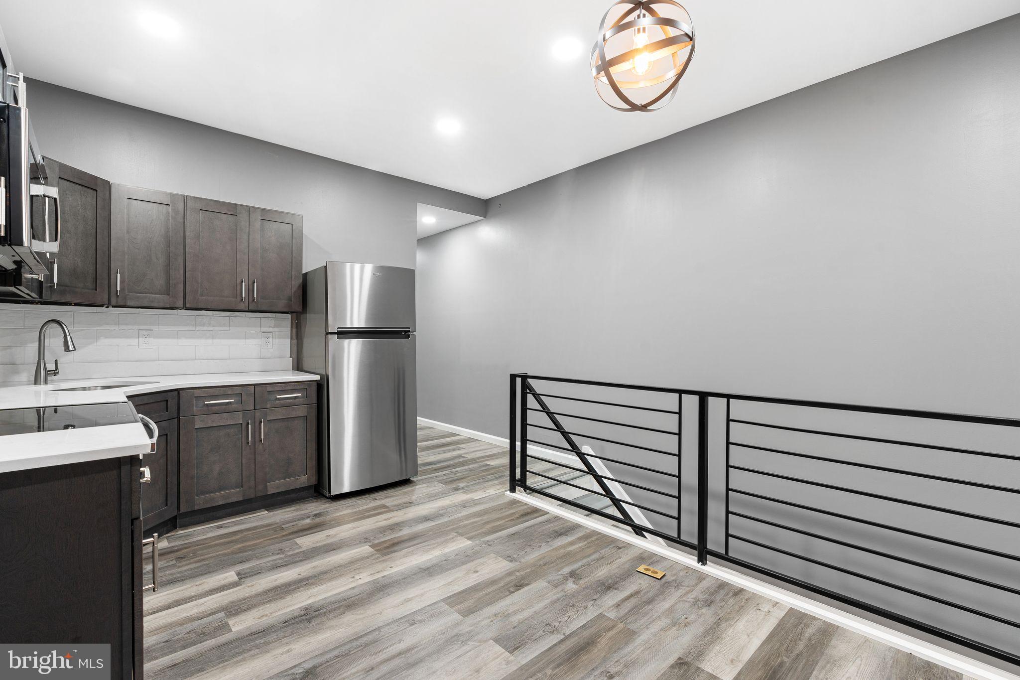 2550 North 12th Street Philadelphia, PA 19133 - Photo 2 of 8 a kitchen with refrigerator and cabinets