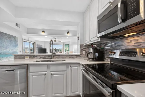 a kitchen with a stove and a sink