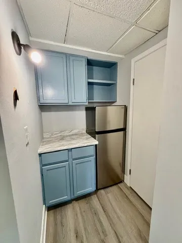 a kitchen with a refrigerator and a sink