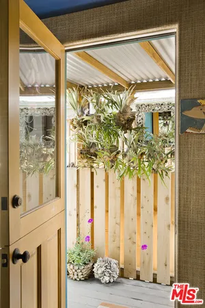 a view of a house with wooden fence