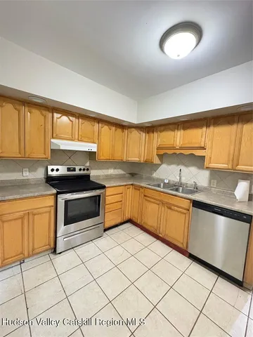 a kitchen with stainless steel appliances granite countertop a sink and cabinets