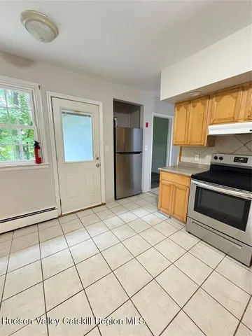 a kitchen with stainless steel appliances a stove a refrigerator sink and cabinets