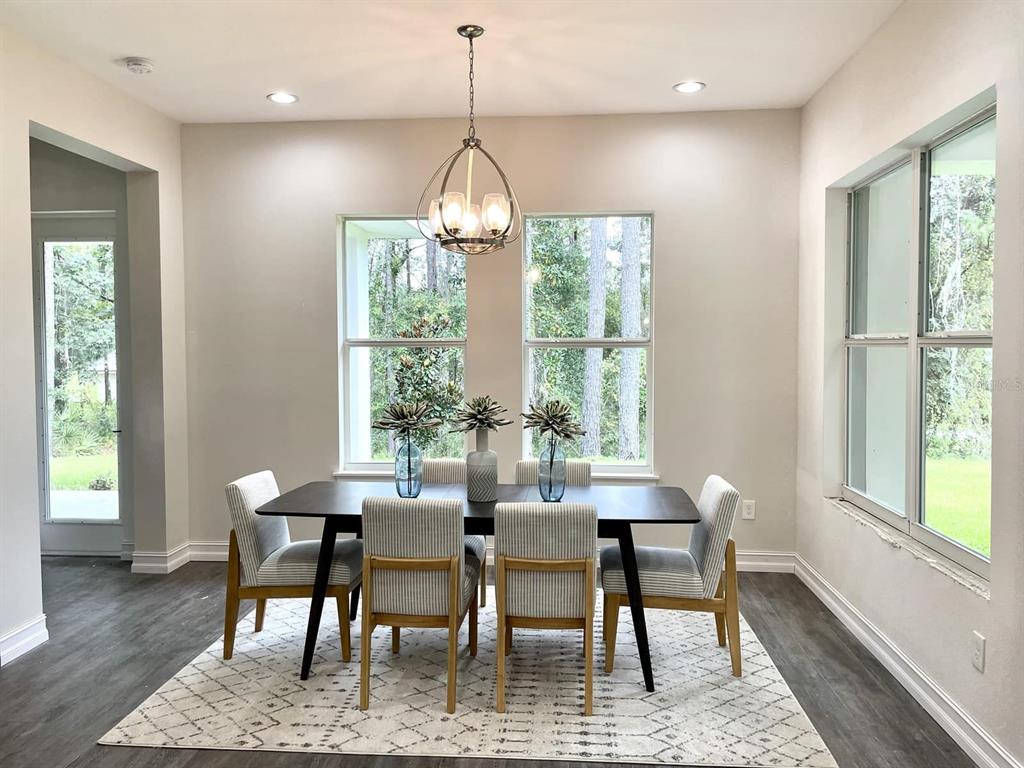 1955 Northwest 79th Loop Ocala, FL 34475 - Photo 5 of 8 a view of a dining room with furniture window and wooden floor