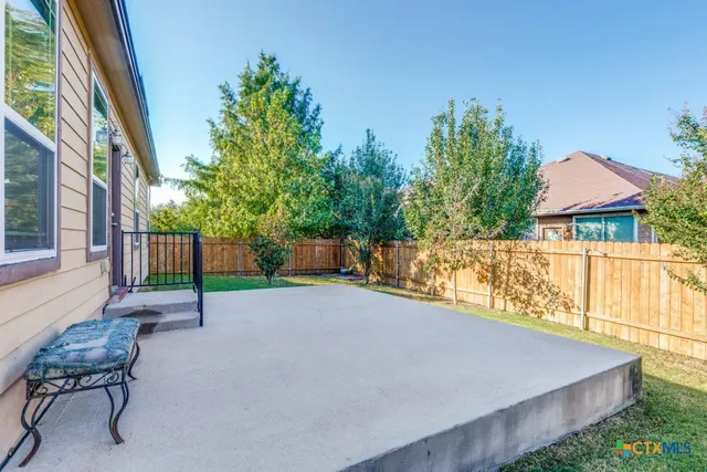 a view of a backyard with sitting area