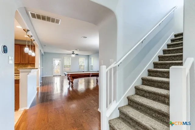 a view of entryway and hall with wooden floor