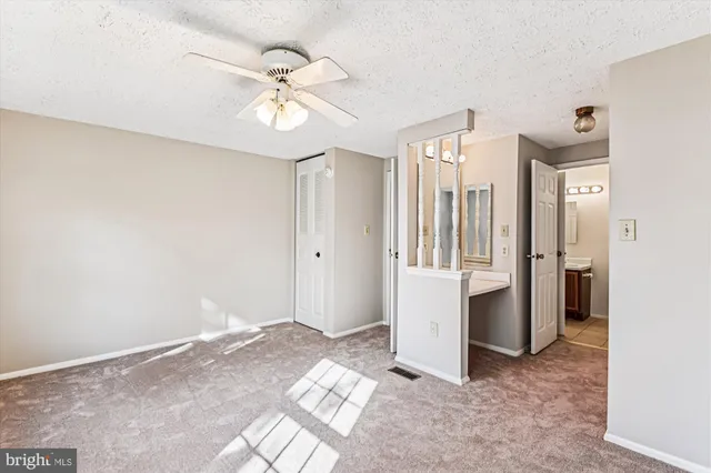 a view of a chandelier fan and entryway