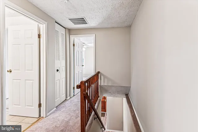 a view of a hallway with staircase