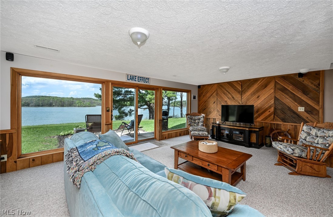 2873 Lodge Road Southwest Sherrodsville, OH 44675 - Photo 34 of 50 The lower level offers this lovely lake view family room with direct access to a lakefront patio.