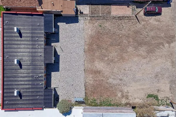 a brick building with a bench and potted plants