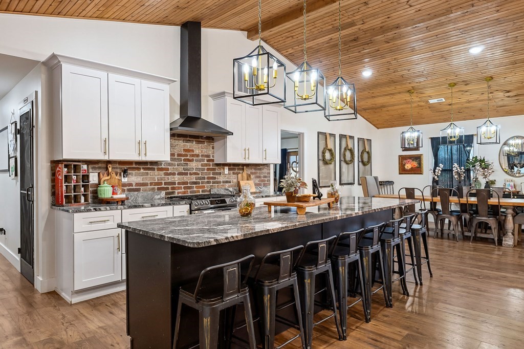 240 Bob Ledbetter Road Livingston, TN 38570 - Photo 14 of 62 a kitchen with stainless steel appliances granite countertop a stove a sink dishwasher and cabinets with wooden floor
