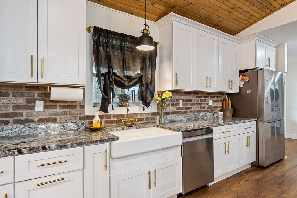 240 Bob Ledbetter Road Livingston, TN 38570 - Photo 15 of 62 a kitchen with a sink dishwasher a stove and white cabinets