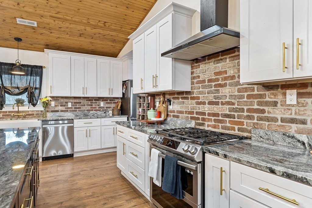 240 Bob Ledbetter Road Livingston, TN 38570 - Photo 16 of 62 a kitchen with granite countertop a stove sink and cabinets