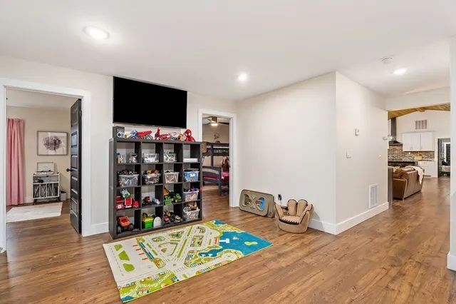 a bedroom with furniture and a wooden floor