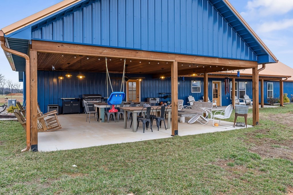 240 Bob Ledbetter Road Livingston, TN 38570 - Photo 47 of 62 a view of a patio with table and chairs under an umbrella