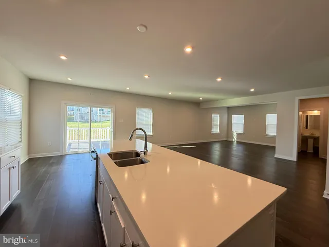a view of a kitchen with a sink and a large window