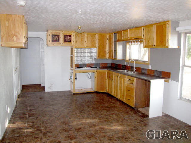 998 21 Road Grand Junction, CO 81505 - Photo 5 of 26 a kitchen with stainless steel appliances granite countertop a stove a sink and a microwave
