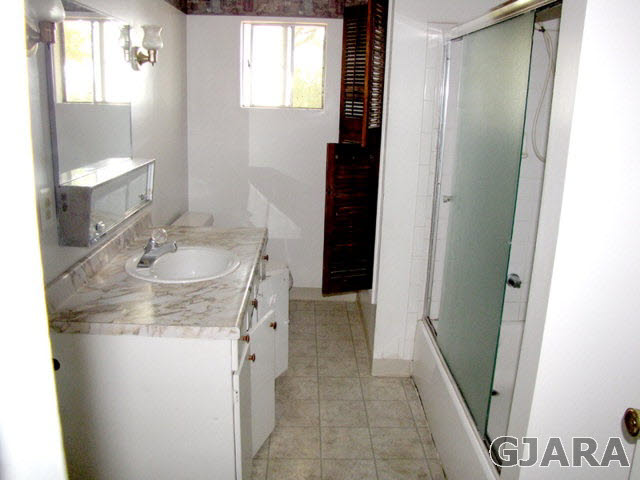 998 21 Road Grand Junction, CO 81505 - Photo 7 of 26 a bathroom with a granite countertop sink and a mirror