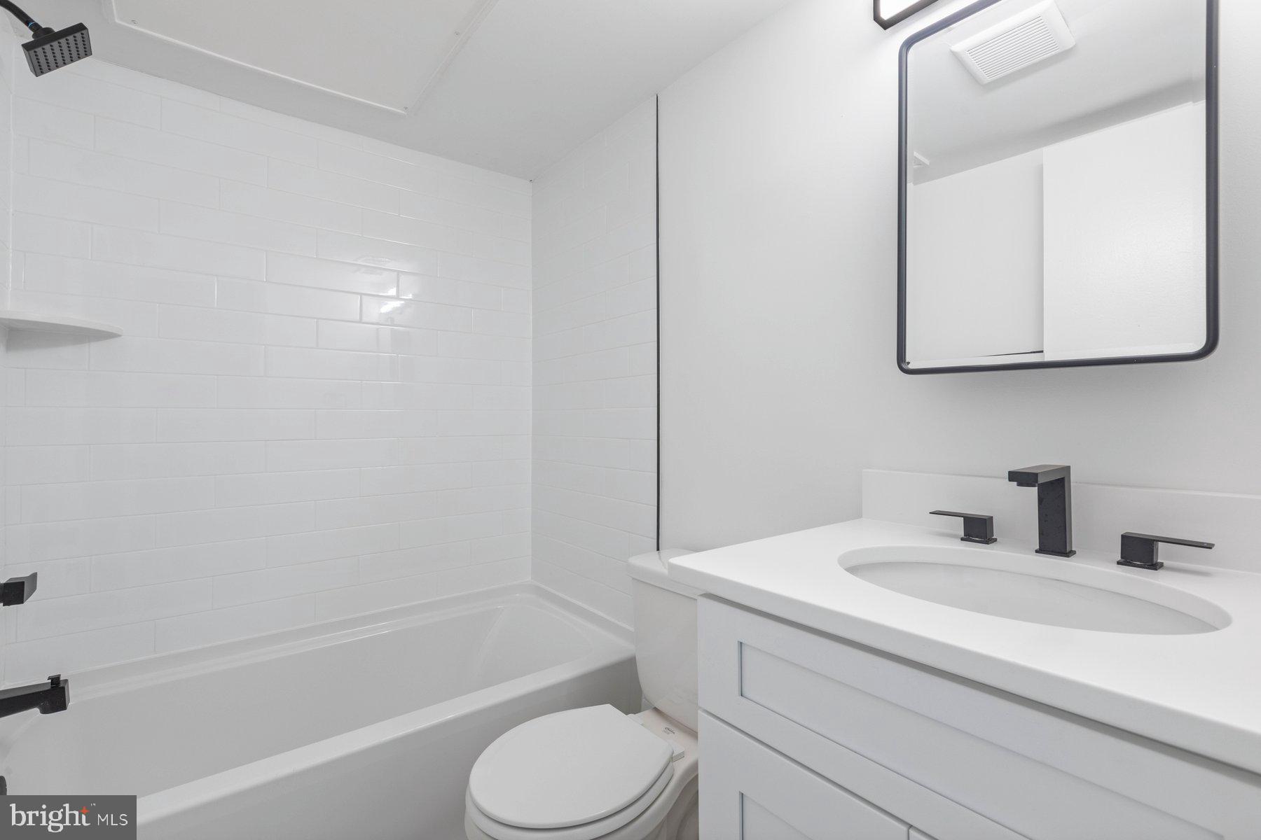 207 South Patrick Street, Unit 104 Alexandria, VA 22314 - Photo 16 of 33 a bathroom with a sink toilet and shower