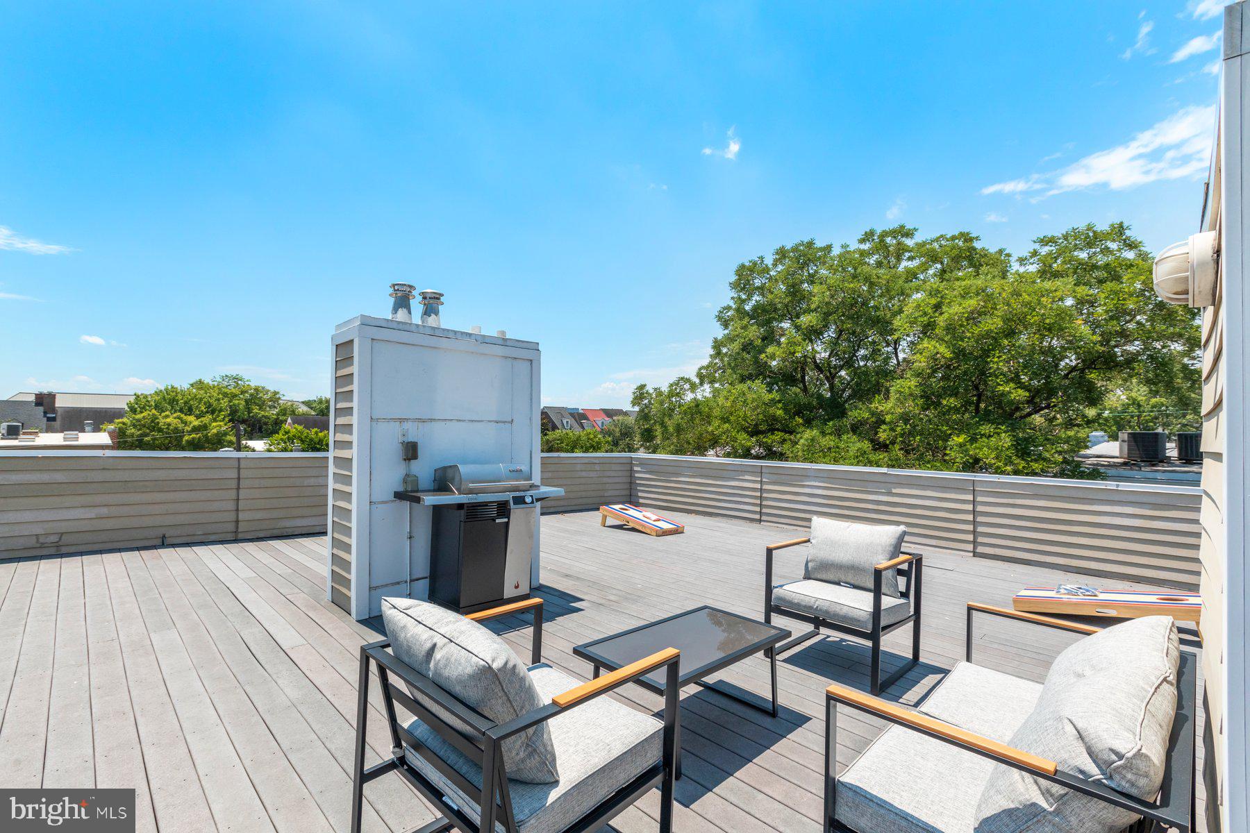 207 South Patrick Street, Unit 104 Alexandria, VA 22314 - Photo 23 of 33 a view of a terrace with furniture and a garden