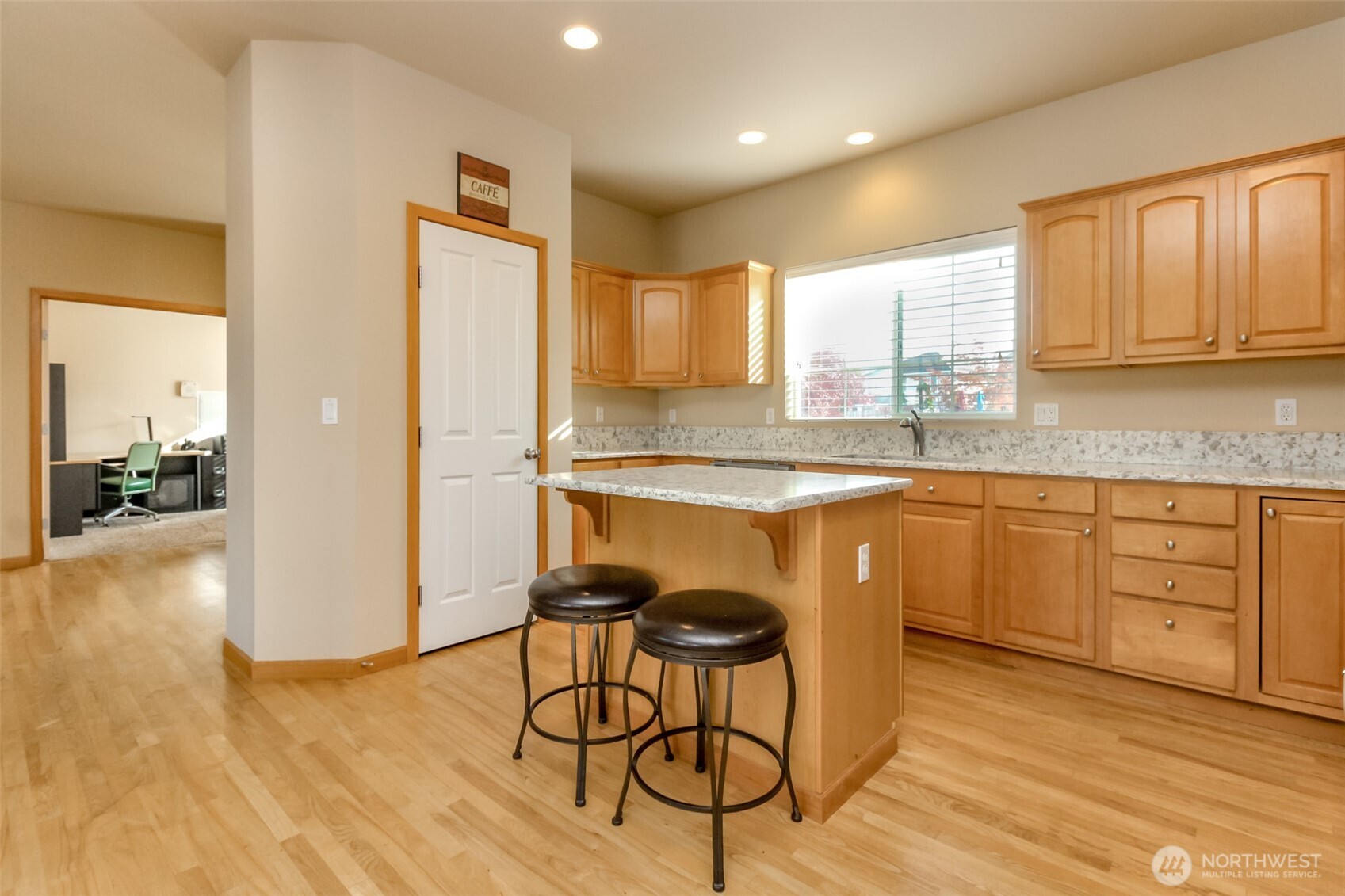1113 O'Farrell Lane Northwest Orting, WA 98360 - Photo 14 of 36 a kitchen with stainless steel appliances granite countertop a refrigerator a sink dishwasher a stove and white cabinets with wooden floor