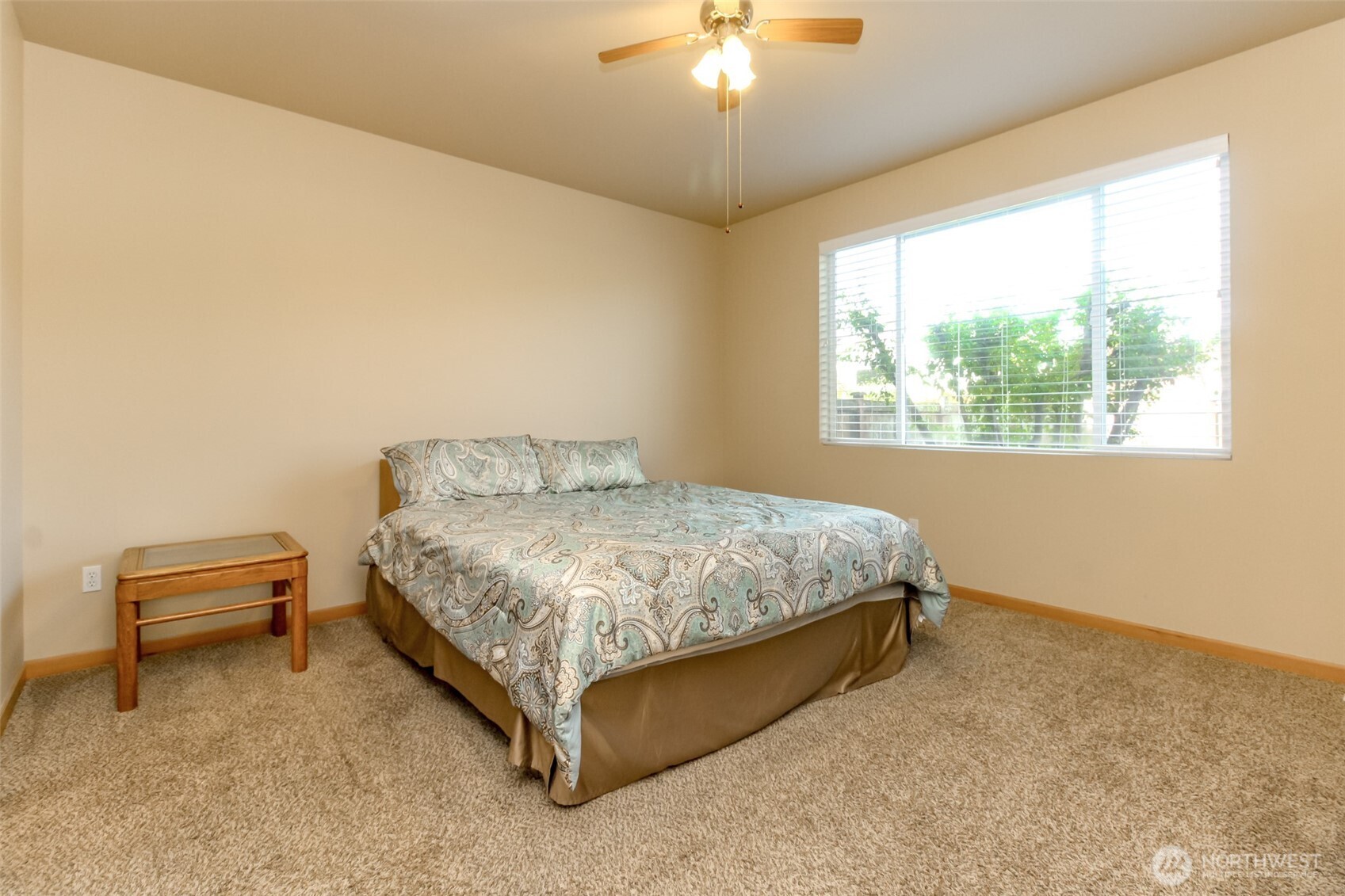 1113 O'Farrell Lane Northwest Orting, WA 98360 - Photo 21 of 36 a bedroom with a bed and a chandelier