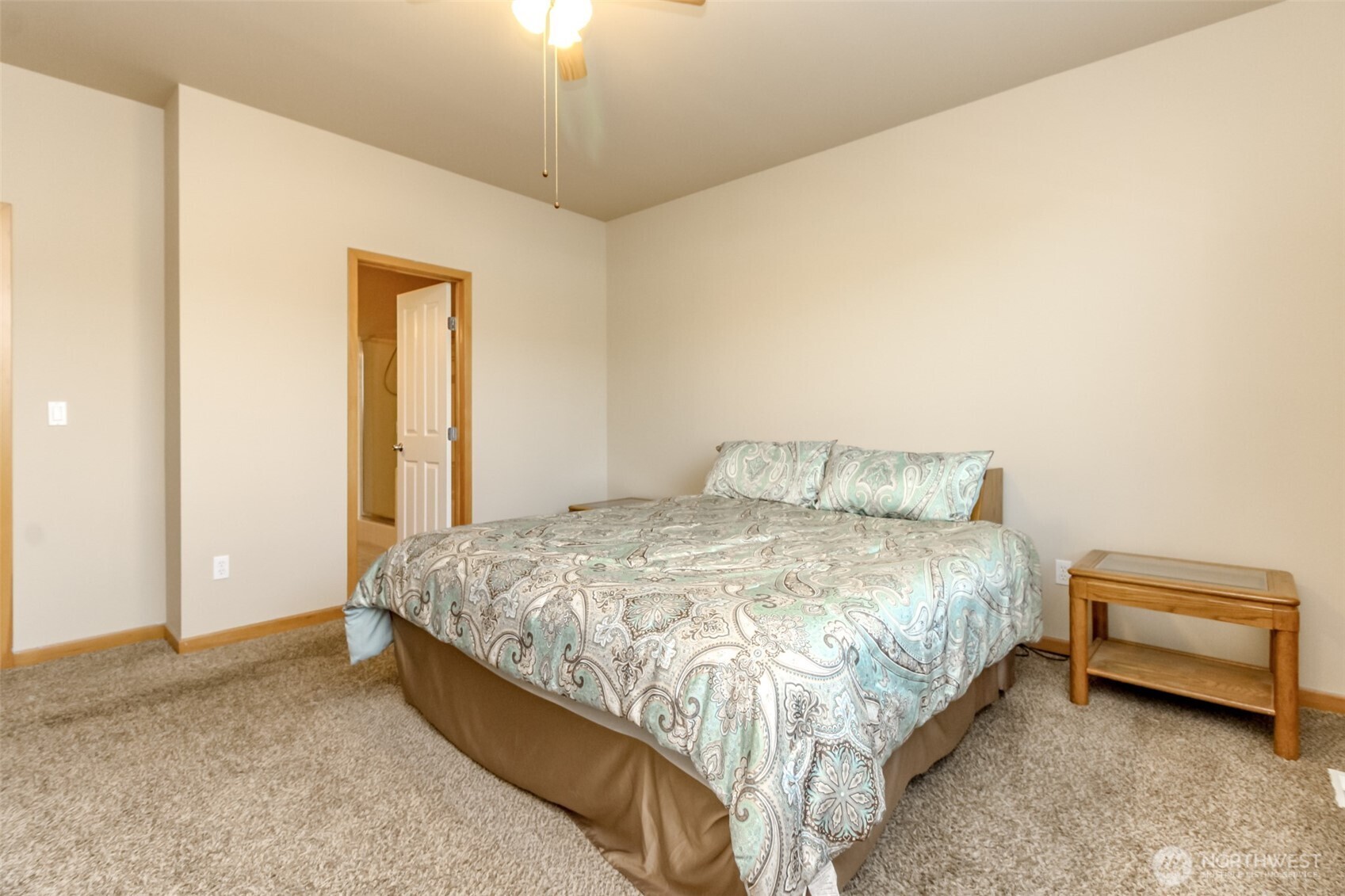 1113 O'Farrell Lane Northwest Orting, WA 98360 - Photo 22 of 36 a spacious bedroom with a bed and a chandelier
