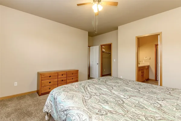 a bedroom with a bed dresser and a window