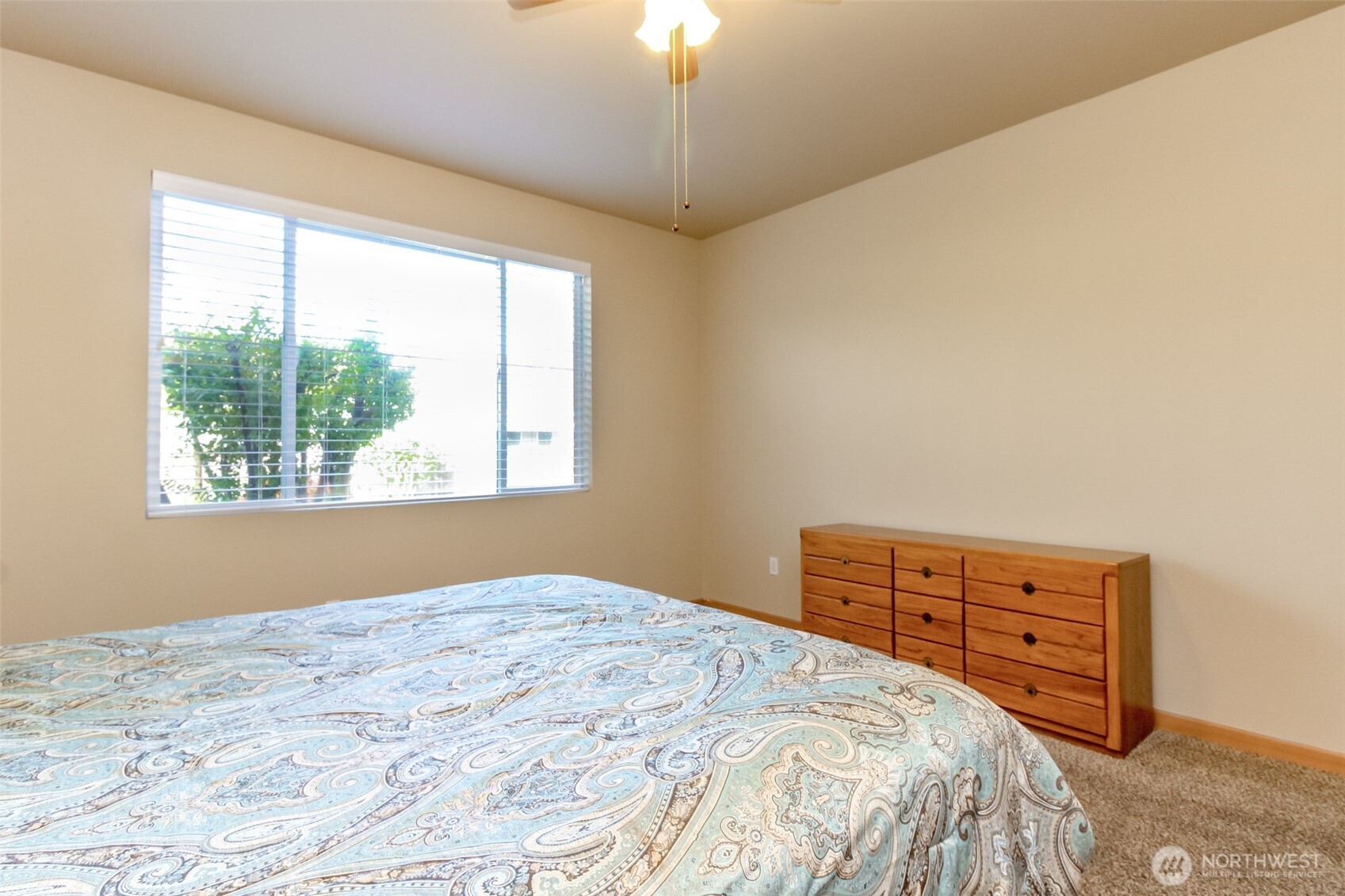 1113 O'Farrell Lane Northwest Orting, WA 98360 - Photo 24 of 36 a bedroom with a bed dresser and a window