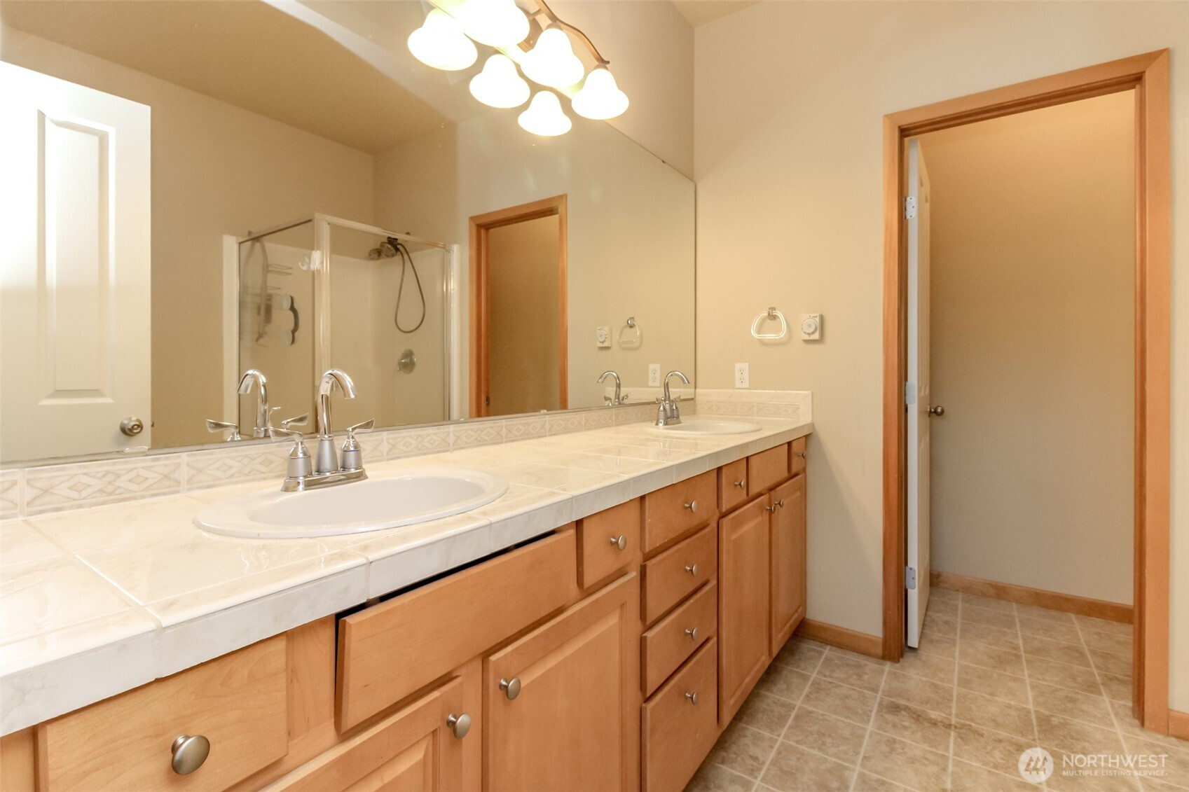 1113 O'Farrell Lane Northwest Orting, WA 98360 - Photo 26 of 36 a bathroom with a double vanity sink and a mirror
