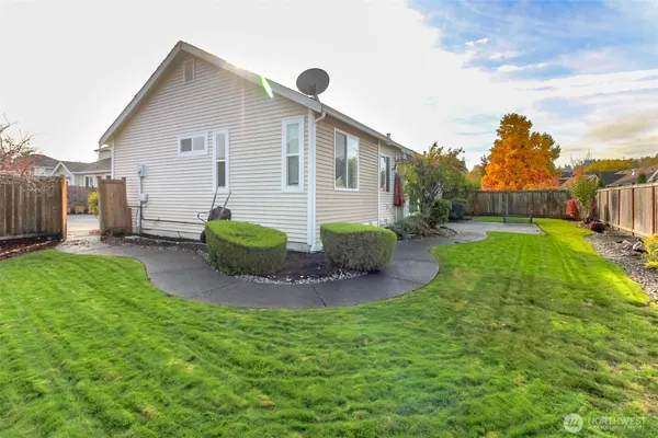 a view of a house with backyard and sitting area