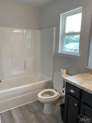 a bathroom with a toilet a sink and a bathtub