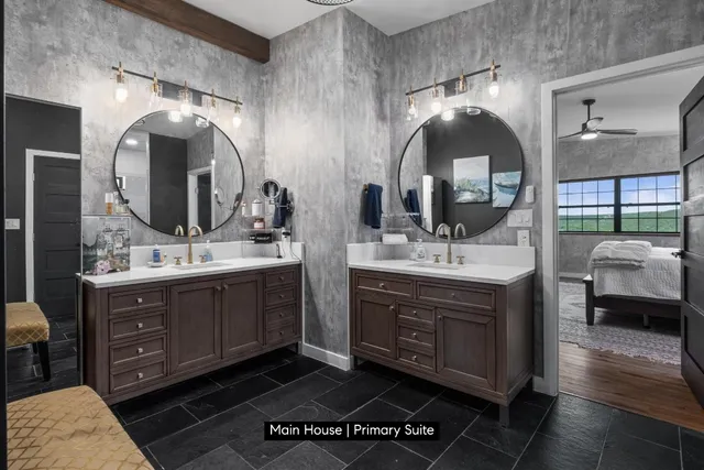 a bathroom with a double vanity sink and a mirror