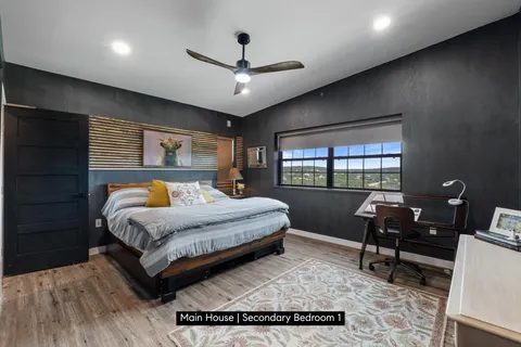 a bedroom with a bed window and wall painting