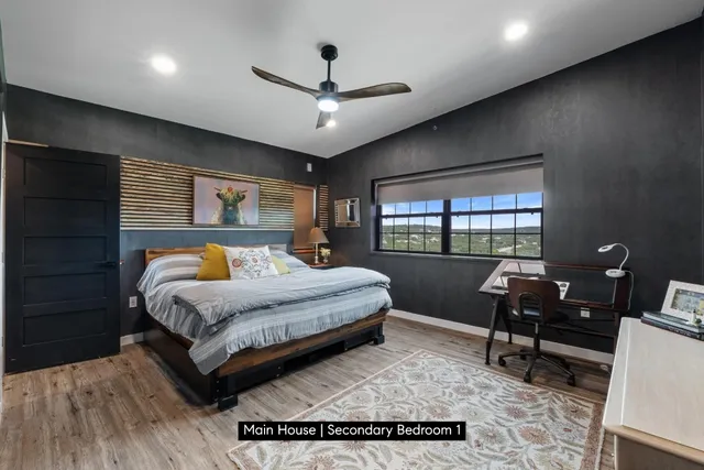 a bedroom with a large bed and a window