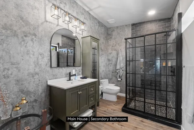 a bathroom with a toilet sink and mirror