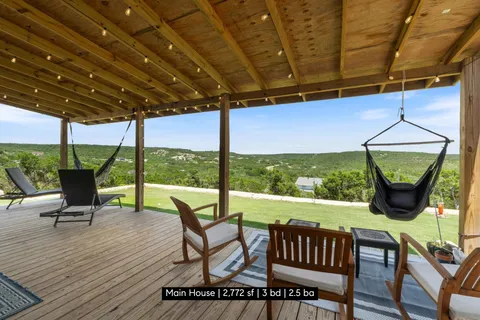 a view of chairs and table in patio with a yard