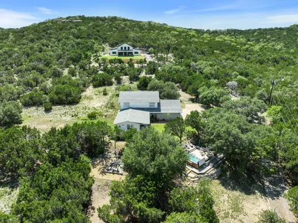 an aerial view of a house with a yard
