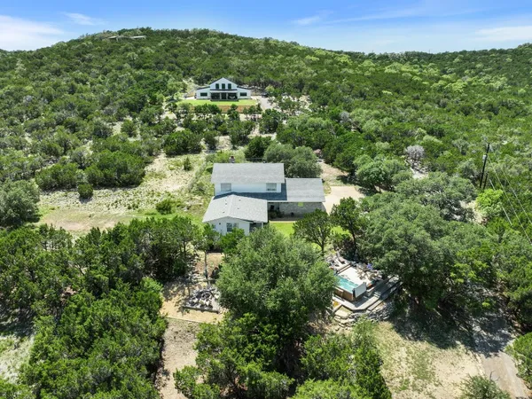an aerial view of a house with a yard